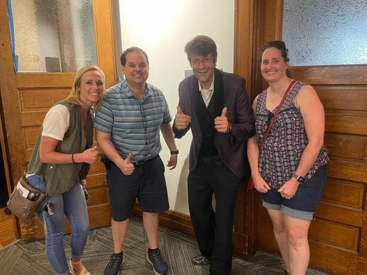 Three people pose happy and satisfied with Jordan Allen after his Neurodivergency Advocacy Magic Show ¨Oh Look It´s Magic¨ in Indianapolis on itś debut night at the IindyFringe Festival.